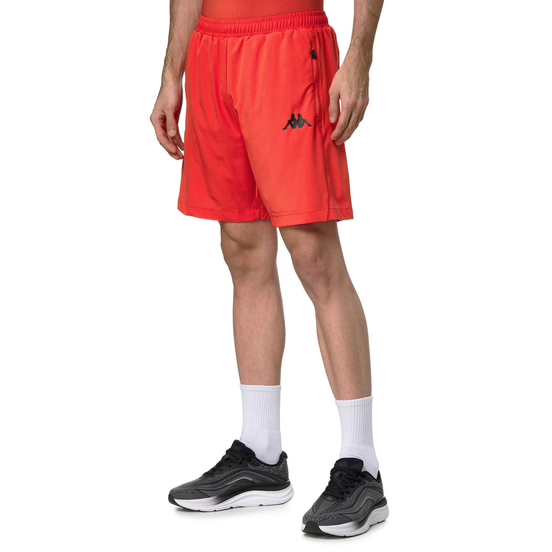 Pantalones cortos deportivos ajustados de color naranja para hombre confeccionados en tejido elástico tejido main