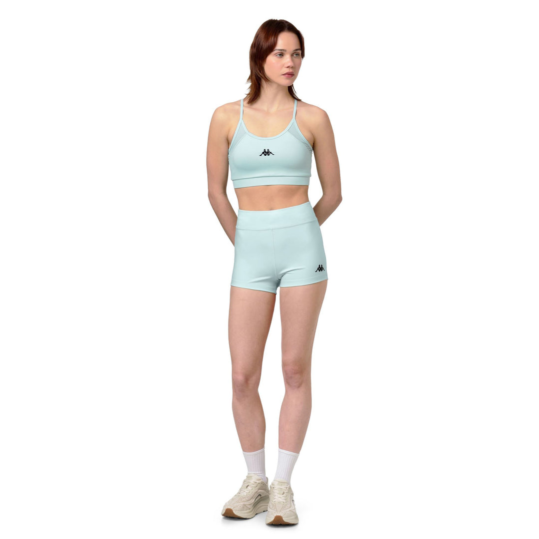 Haut de sport bleu moulant pour femme avec empiècements en mesh main