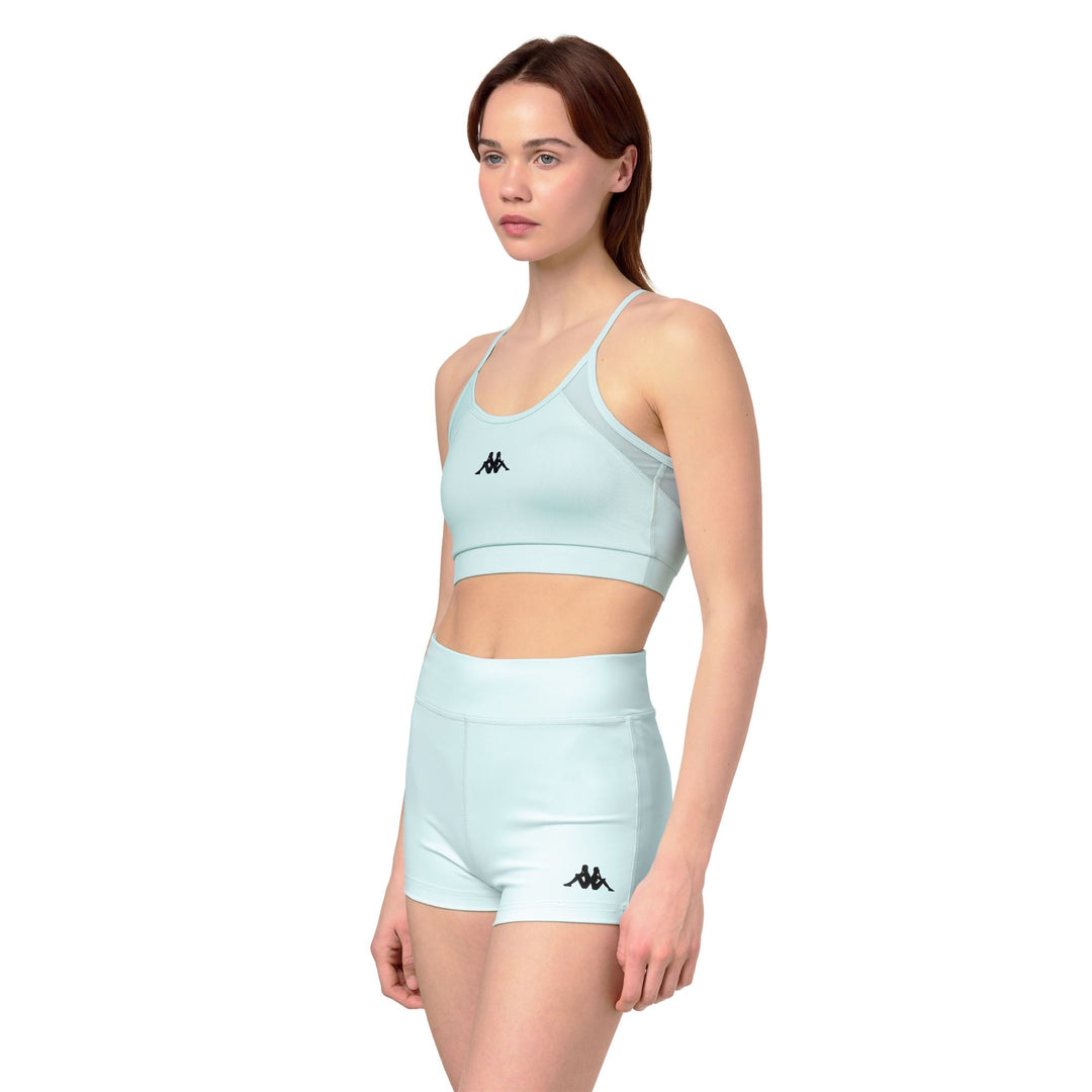 Haut de sport bleu moulant pour femme avec empiècements en mesh main