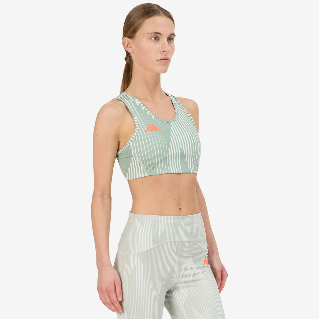 Haut d'entraînement gris moulant pour femme en jersey stretch main